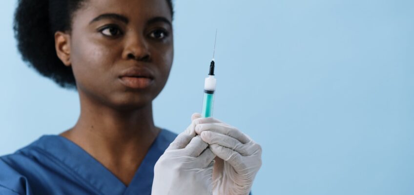 close up shot of a female nurse holding a syringe